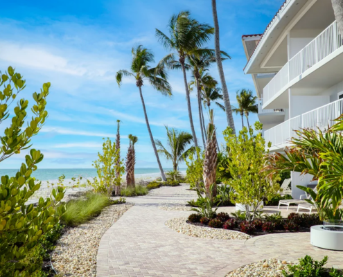 LaPlaya Beach & Golf Resort - Palm-Lined Walkway and Balconies