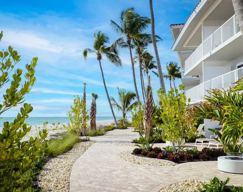 LaPlaya Beach & Golf Resort - Palm-Lined Walkway and Balconies