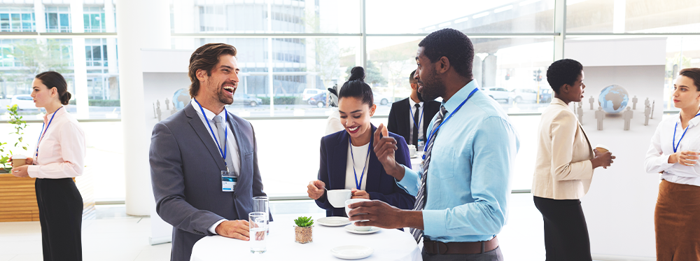 Diversity and Inclusion in Hospitality - people from diverse backgrounds networking at an event around a table