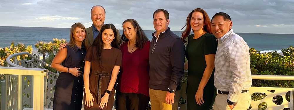 The Teneo Leadership Team breaks to enjoy the beach views during the 2024 Teneo Executive Meeting at Amrit.