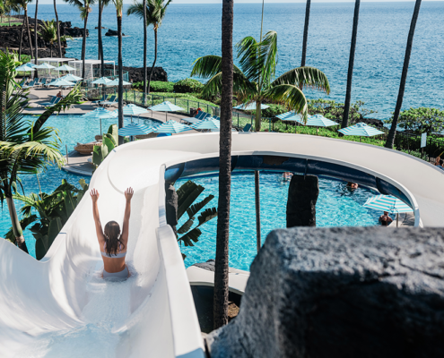 Girl sliding down the waterslide at the OUTRIGGER Kona Resort & Spa