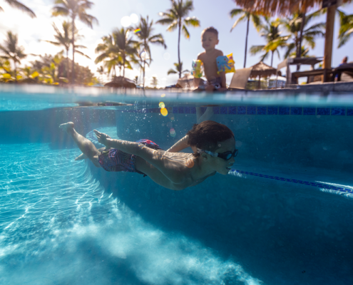 Two kids playing at the pool at OUTRIGGER Kona Resort & Spa