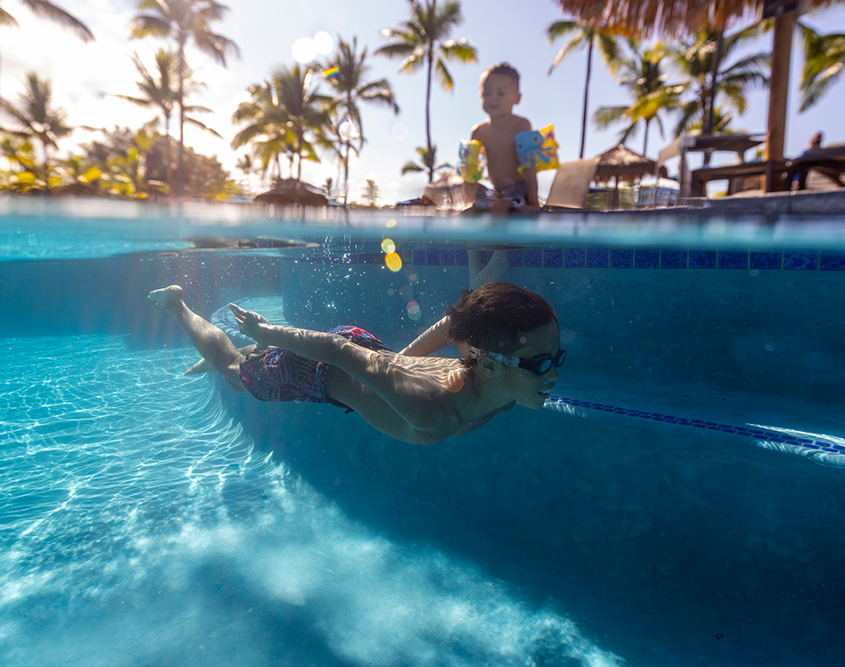 Two kids playing at the pool at OUTRIGGER Kona Resort & Spa