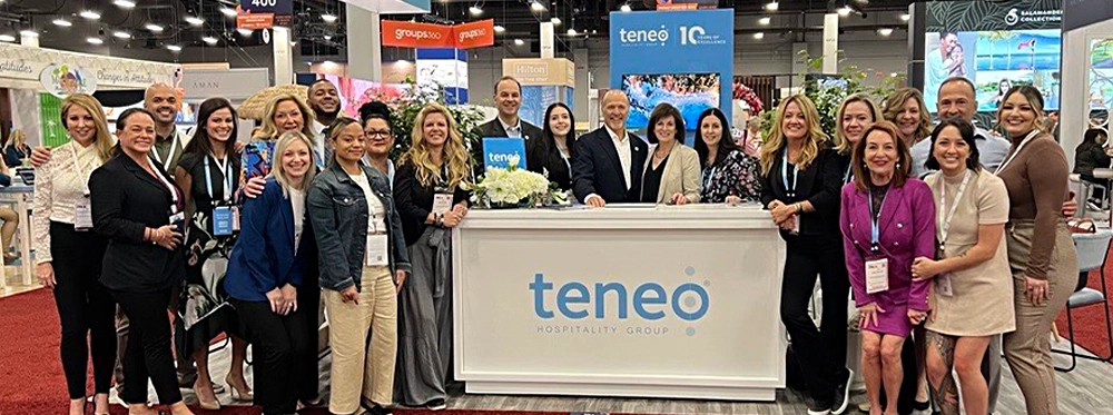 Team Teneo standing in front of booth at IMEX